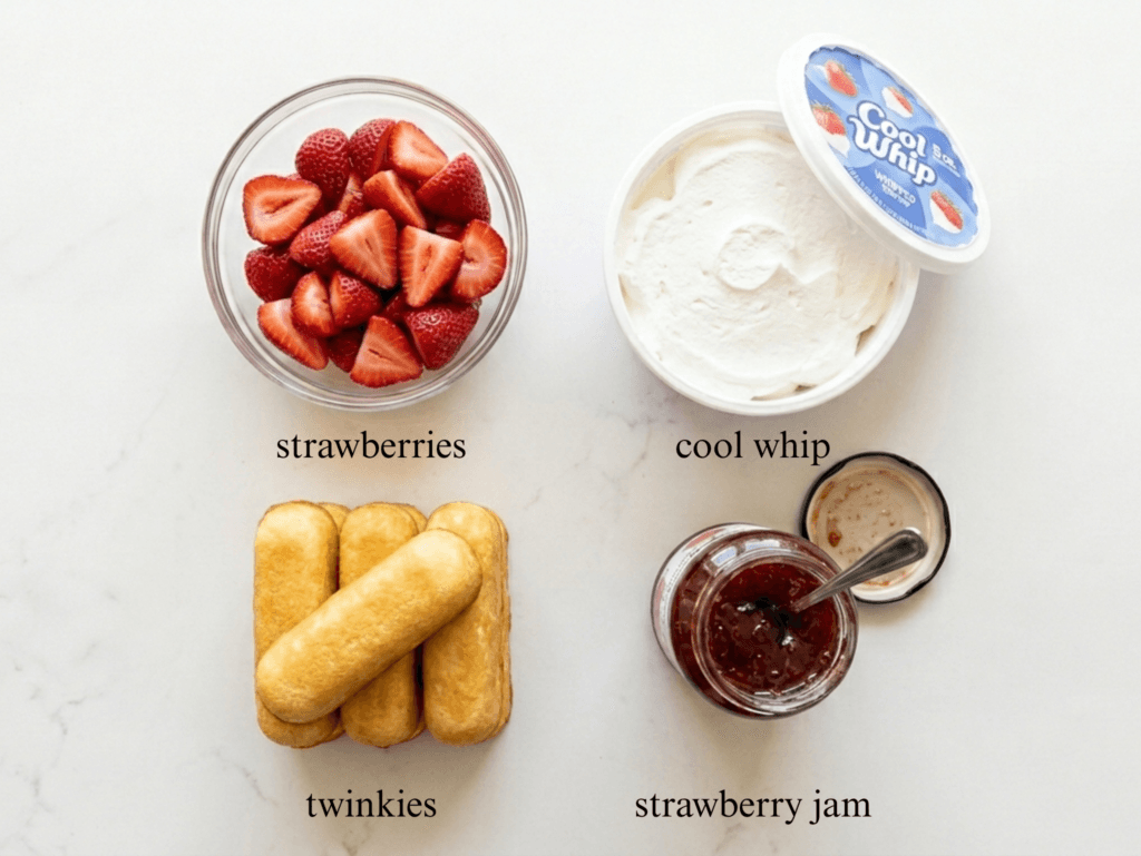 A top-down layout of the four ingredients on a light marble counter: a package of Twinkies, a clear glass bowl of sliced fresh strawberries, a box of strawberry glaze, and a tub of white whipped topping.