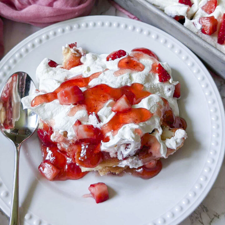 Feature post image, strawberry trifle 4 ingredient cake on a white plate.