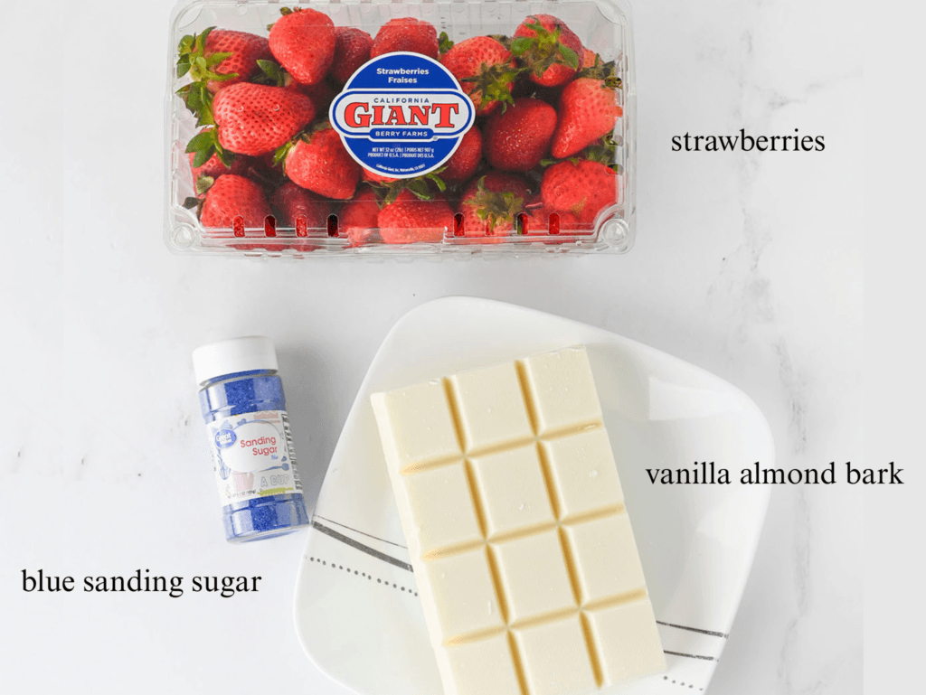 Ingredients including a container of strawberries, a bottle of blue sugar, and a block vanilla almond bark.