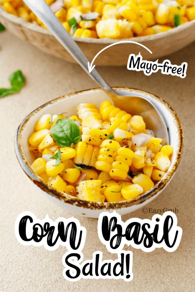 Small serving bowl filled with seasoned corn and fresh basil leaves.