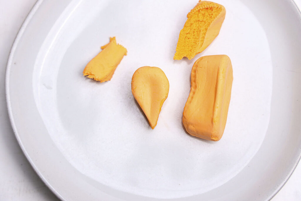 a white plate with circus peanuts on it.