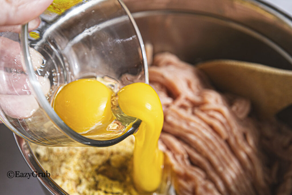 Adding the eggs to the chicken mixture.