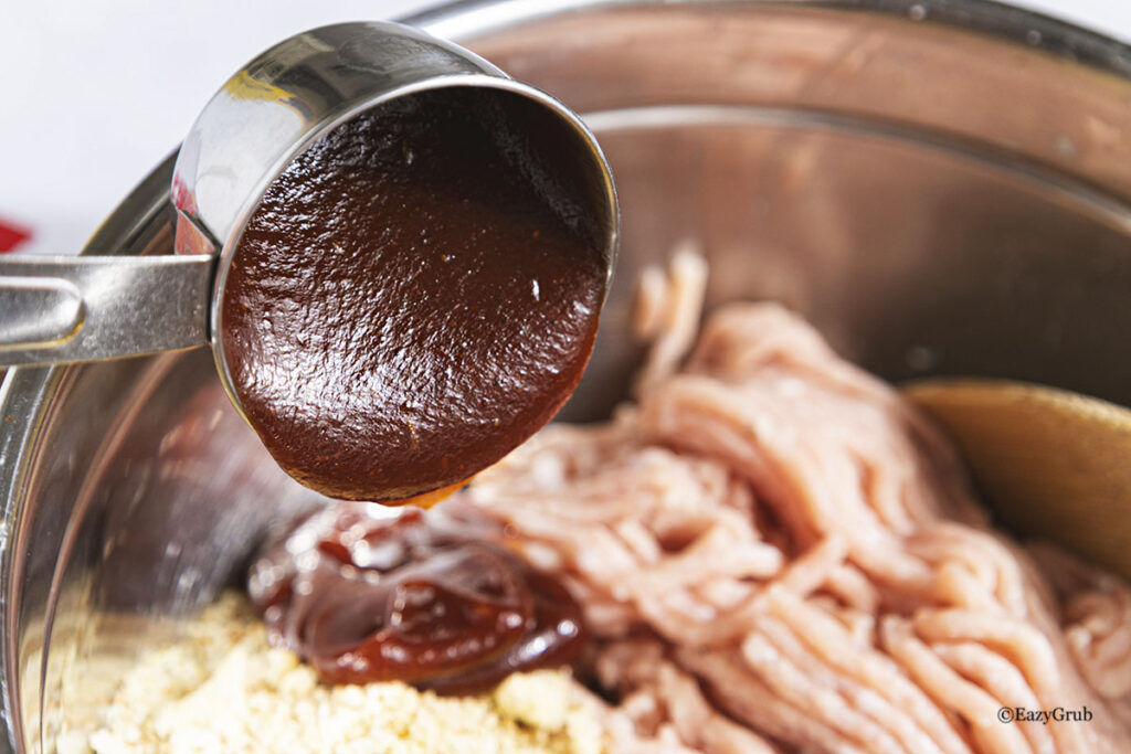 Adding bbq sauce to the mixture.