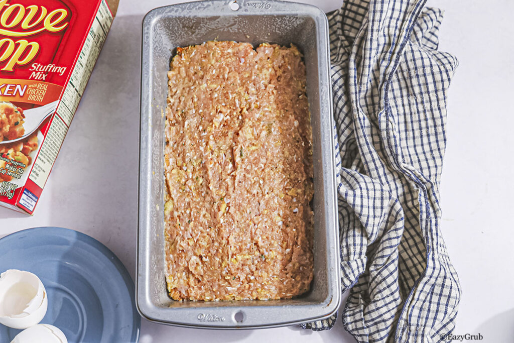 The raw meatloaf in a baking tin.