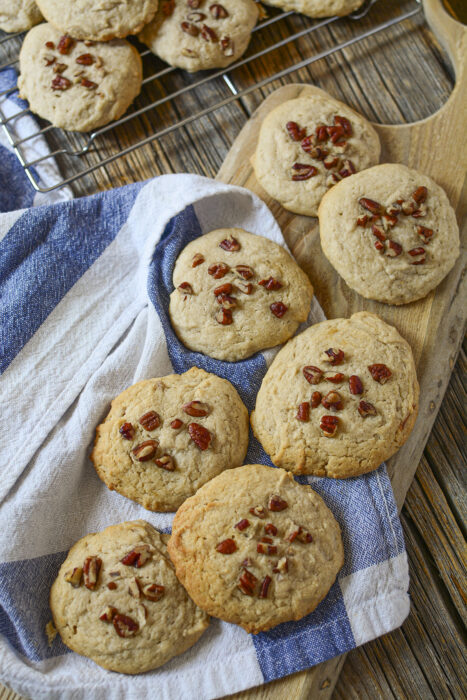 Cookies on a tea towel and a wood board.