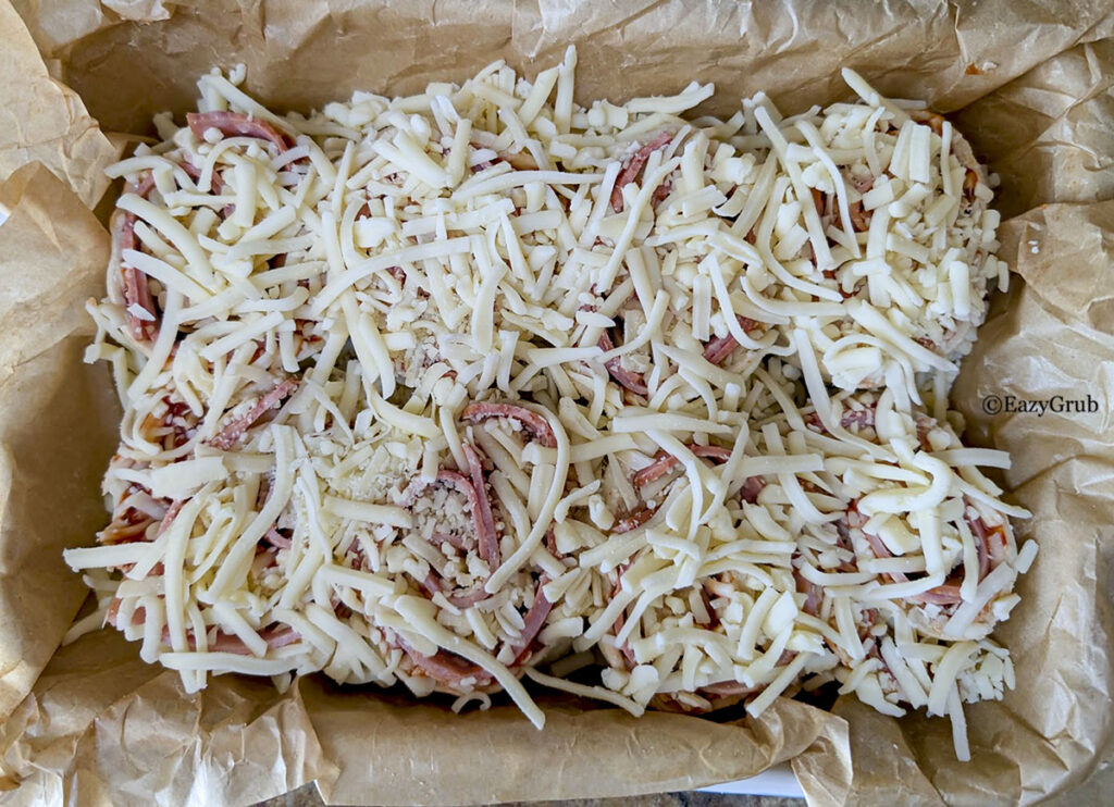 Extra cheese scattered on top of the rolls.